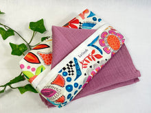 Load image into Gallery viewer, Cotton dispenser box in a brightly coloured pattern with 12 Pink cotton handkerchiefs folded inside
