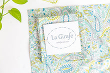 Load image into Gallery viewer, One Green Paisley napkin folded in a square on top of a flat a Green Paisley napkin
