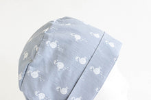 Load image into Gallery viewer, Close up of Cloth scrub hat with White Flamingo pattern on light Grey ground
