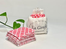 Charger l'image dans la galerie, An Ivory cotton pouch with a stack of Salmon patterned makeup remover pads