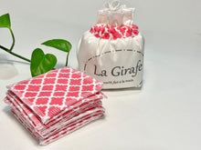 Charger l'image dans la galerie, An Ivory cotton pouch with a stack of Salmon patterned makeup remover pads