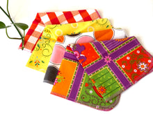 Charger l'image dans la galerie, Four folded towels with Plaids, Circles and Floral patterns in bright Pink, Orange, Yellow and Green