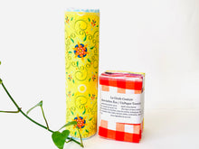 Charger l'image dans la galerie, A stack of folded towels and one rolled with Plaids, Circles and Floral patterns in bright colours