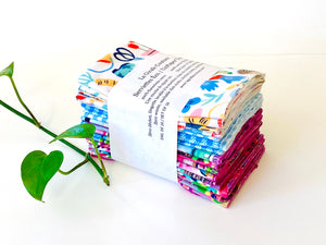 A stack of folded towels with Butterfly, Checks and Garden patterns