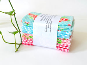 A stack of folded towels with Roses and Checks patterns in Blue and Pink