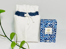 Charger l'image dans la galerie, One small bag in off-white cotton canvas with a Blue Denim trim next to a bottle of perfume