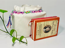 Load image into Gallery viewer, One big bag in off-white cotton canvas with a Butterfly trim next to a book
