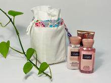 Load image into Gallery viewer, One small bag in off-white cotton canvas with a Butterfly trim next to 3 small bottles of lotion
