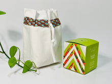 Load image into Gallery viewer, One small bag in off-white cotton canvas with a Peacock trim next to a small box