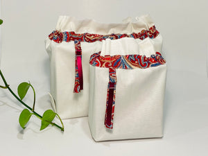 Two bags in off-white cotton with a Red Paisley trim. One bag is big and one small.