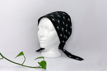 Load image into Gallery viewer, Semi Left view of Scrub Cap with White Flamingo print on Black ground