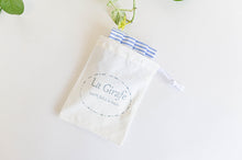 Load image into Gallery viewer, Ivory pouch printed with La Girafe logo and containing one folded face mask
