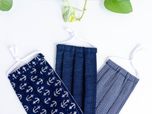 Charger l'image dans la galerie, Closeup of Three face masks one Silver Anchors on Navy one Blue Denim one Silver Squares on Navy
