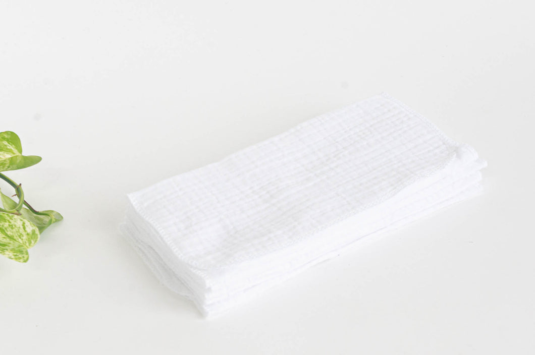 12 White cotton handkerchiefs folded in half