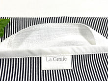 Load image into Gallery viewer, Close up of a Grey stripes dispenser box in cotton with 12 White handkerchiefs folded inside
