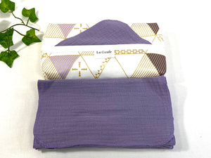 Cotton dispenser box in a Geometric pattern with 12 Lilac cotton handkerchiefs folded next to box