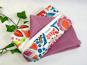 Cotton dispenser box in a brightly coloured pattern with 12 Pink cotton handkerchiefs folded inside