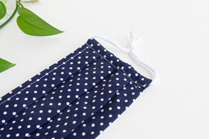 Closeup of One face mask pleated, Navy ground with White Polka Dots