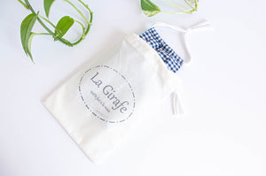 Ivory Cotton pouch with 100% hand made printed logo and containing a folded cotton face mask