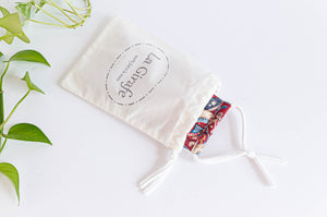 Ivory Cotton pouch with 100% handmade printed logo and containing a folded cotton face mask