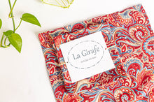 Load image into Gallery viewer, One Red Paisley napkin folded in a square on top of a flat a Red Paisley napkin
