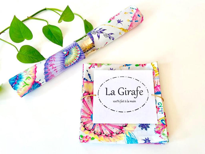 One rolled and one folded napkins with a Japanese Umbrellas pattern on White ground