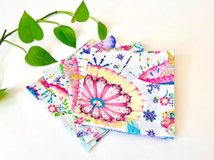 Four folded napkins with a Japanese Umbrellas pattern on White Ground