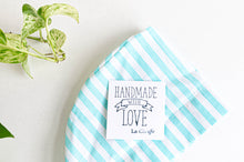 Load image into Gallery viewer, Close up of scrub hat with Aqua Stripes on White with note handmade with love
