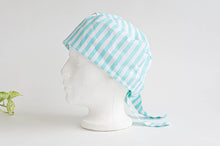 Load image into Gallery viewer, Left Side view of scrub hat with Aqua Stripes on White
