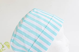 Close up of scrub hat with Aqua Stripes on White