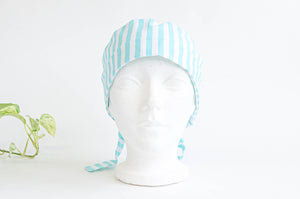 Front view of scrub hat with Aqua Stripes on White