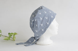 Side view of Cloth scrub hat with White Flamingo pattern on light Grey ground