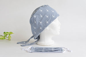 Side view of Cloth scrub hat with White Flamingo pattern on light Grey with a matching face mask
