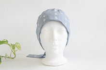 Load image into Gallery viewer, Front view of Cloth scrub hat with White Flamingo pattern on light Grey ground
