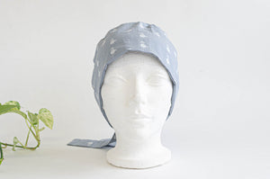 Front view of Cloth scrub hat with White Flamingo pattern on light Grey ground