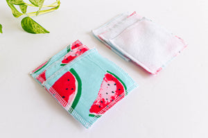 Pile of cloth makeup remover with watermelon pattern on one side and white fleece on the other side