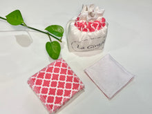 Load image into Gallery viewer, An Ivory cotton pouch with a stack of Salmon patterned makeup remover pads
