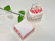 Load image into Gallery viewer, An Ivory cotton pouch with a stack of Salmon patterned makeup remover pads
