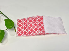 Load image into Gallery viewer, A stack of Salmon patterned makeup remover pads with one side in White Polar fleece

