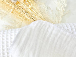 Closeup of the edge of a white cotton handkerchief