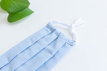 Load image into Gallery viewer, Close up of Blue cloth fcae mask pleated with white straps
