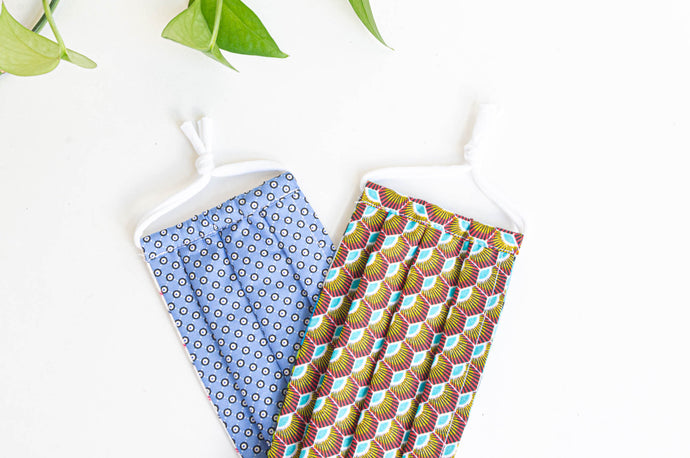 2 Face Masks, 1 with  Blue Ground and Black Circles, 1 with Brown and Blue Peacock pattern
