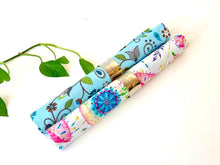 Load image into Gallery viewer, Tow rolled napkins one with a Floral pattern on Blue ground, one with a Japanese Umbrellas pattern
