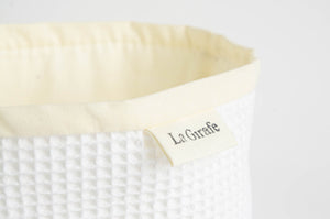 Close up of a basket in White Waffle cotton to hold used hankies