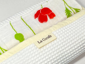 Close up of 12 cotton hankies with Red Poppy Flower pattern and a white box in waffle cotton