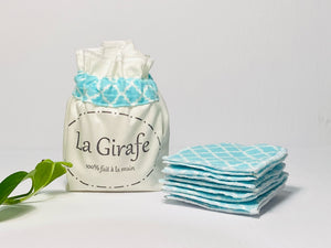 Ivory cotton pouch printed with La Girafe Couture and a stack of Aqua printed makeup remover pads