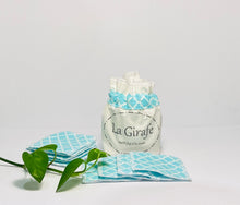 Load image into Gallery viewer, Ivory cotton pouch printed with La Girafe Couture and a stack of Aqua printed makeup remover pads
