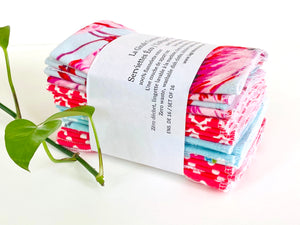 A stack of folded towels with Flamingo, Lamas and Polka Dots patterns in Pink and Blue