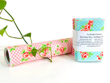 Charger l&#39;image dans la galerie, A stack of folded towels with Roses and Checks patterns in Blue and Pink and one rolled towel
