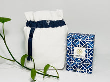 Load image into Gallery viewer, One small bag in off-white cotton canvas with a Blue Denim trim next to a bottle of perfume
